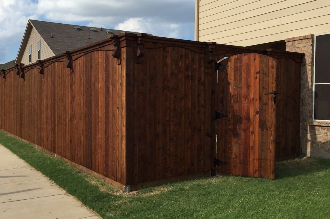 8' side by side cedar fence with arch trim and corbles